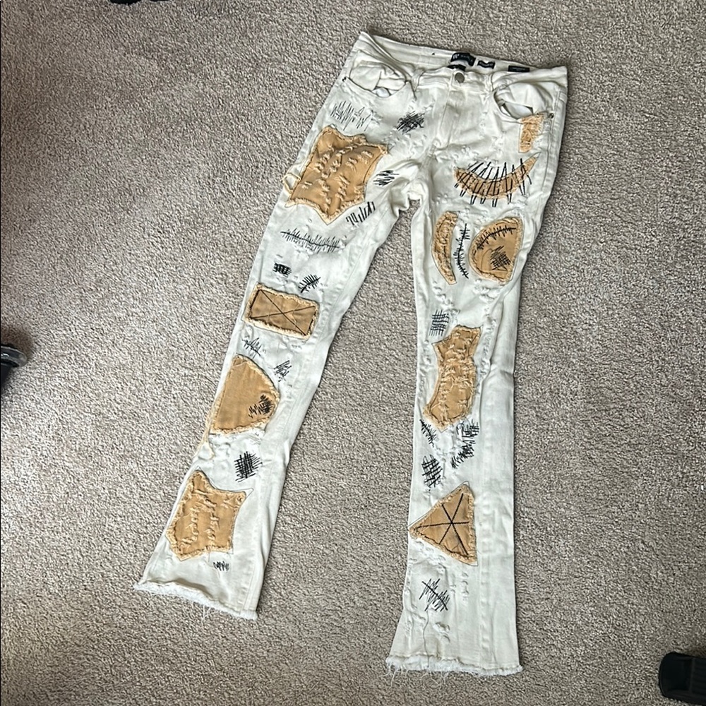 White and Tan Bootcut Jeans with Distressed Details